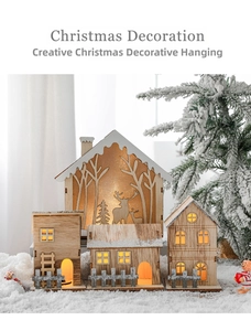 Close-up of wooden Christmas house ornaments with warm LED lights in a snowy forest scene