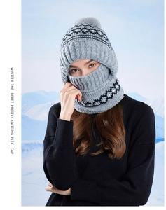 Close-up of winter knitted thermal hood with geometric pattern and large grey pompom
