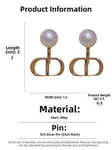 Detail view of S925 silver stud earrings with faux pearls and CD logo charm