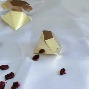 Detail view of gold diamond-shaped gift boxes in assembled and flat-lay states