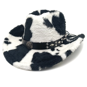 Detail of plush cow print cowboy hat with studded leather band and metal buckle
