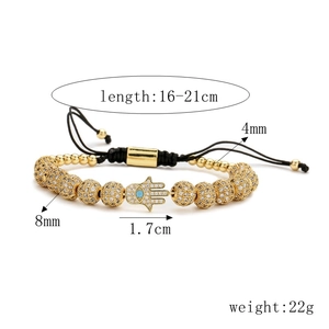 Detailed view of adjustable Hamsa hand bracelet with zircon beads on black woven cord