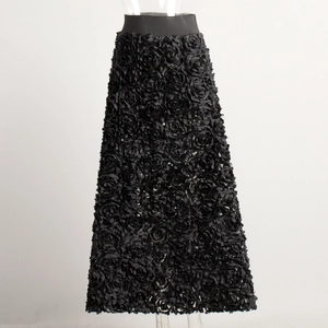 Detail of 3D 3D rose textured fabric on high waist black A-line maxi skirt for women
