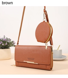 Detail of brown leather crossbody bag set with detachable round coin purse and gold hardware