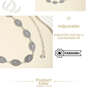Detail of silver vintage ethnic metal waist chain with sunburst texture and adjustable links