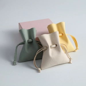 Close-up showing soft microfiber texture and drawstring detail of colorful jewelry pouches.