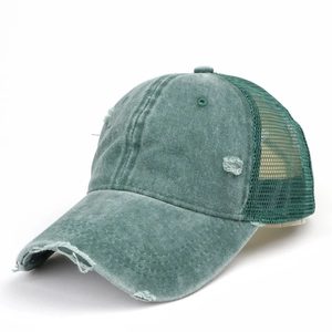 Close-up of distressed grey-green trucker hat showing mesh panels and frayed fabric details