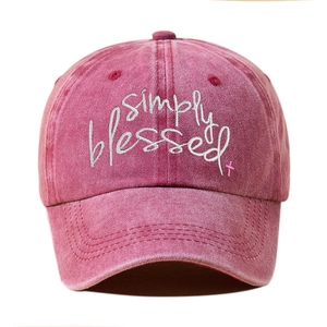 Detail view of Simply Blessed embroidery on washed pink cotton vintage baseball cap