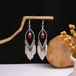 Bohemian silver drop earrings with red bead and detailed metallic feather charms