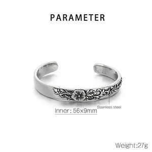 Detailed macro view of vintage floral relief carvings on a 56x9mm stainless steel cuff bracelet