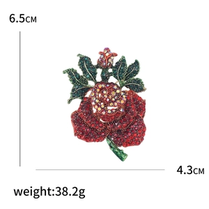 Sparkling crystal rose flower brooch with red rhinestones measuring 6.5cm by 4.3cm