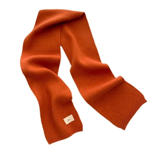 Vibrant orange knitted scarf for autumn and winter made of soft wool blend material