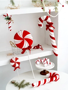 Macro shot of red and white striped candy canes with plush velvet bows for Christmas trees