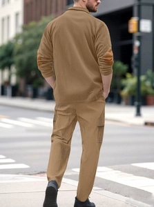 Rear view of men's casual corduroy two-piece set in khaki brown on an urban street