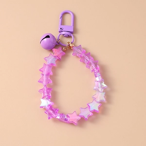 Close-up of purple star beaded keychain featuring a matching purple bell and plastic hook