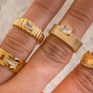 Vintage 18k gold plated rings with emerald cut cubic zirconia on female hand