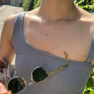 Minimalist 925 sterling silver necklace with irregular hollow heart pendant on female model