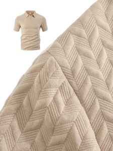 Detailed macro view showing khaki knit polo shirt fabric with textured herringbone pattern