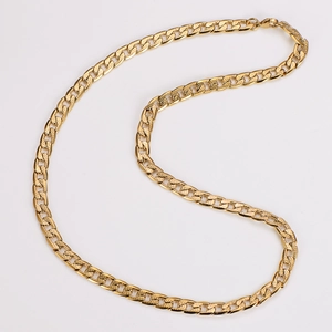 Close-up of golden Cuban link chain featuring intricate textured engraving and lobster clasp