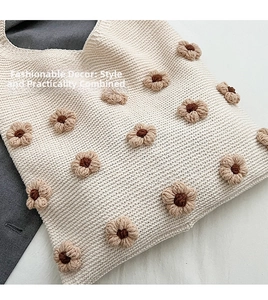 Close-up of a cream knit tote bag showing textured stitch and 3D floral details