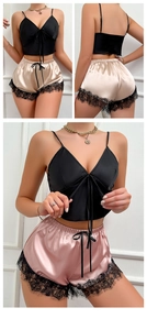 Detailed view of women's satin sleepwear set featuring eyelash lace hem and V-neck top