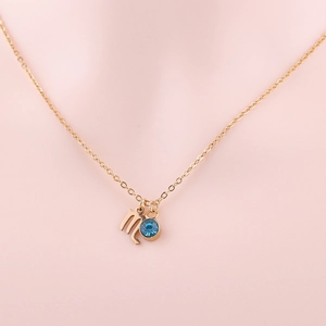 Gold stainless steel Virgo zodiac necklace featuring a blue birthstone and fine chain