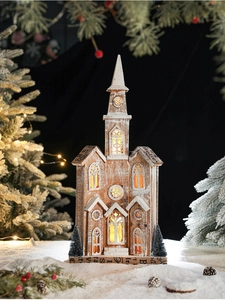 Detail of a lighted Christmas wooden church with warm glow through cutout windows