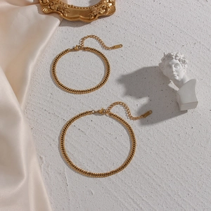 Detail view of gold Cuban and flat snake chain bracelets with lobster clasps and extenders