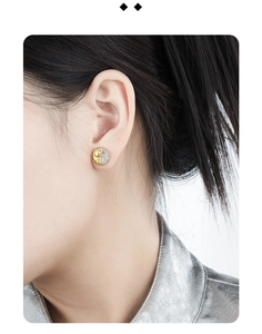Close-up of model wearing two-tone S925 silver round earrings with paved zircons