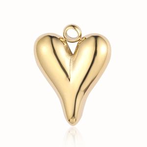 Macro shot of gold stainless steel heart pendant with polished surface for DIY jewelry