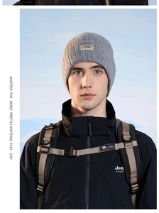 Detail view of a gray ribbed knit beanie with brand label for winter outdoor activities
