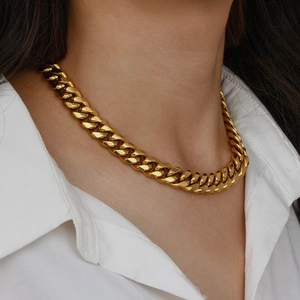 Fashionable gold chunky Cuban link chain necklace for women shown on a model