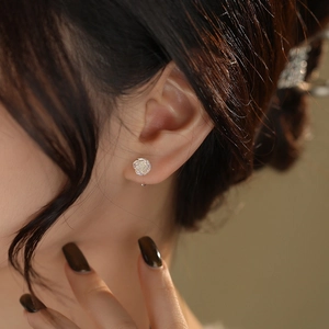 Elegant S999 sterling silver rose flower earrings on model with high polish finish