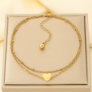 Zweilagiges goldenes Herz-Fußkettchen auf Seide für einen luxuriösen Modestil
