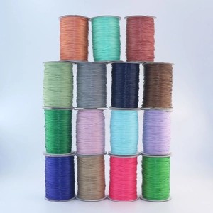 Macro shot of 1mm colorful waxed polyester cords in rolls for DIY jewelry making