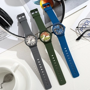 Flat lay of quartz watches with camouflage dials in army green, grey, and navy blue