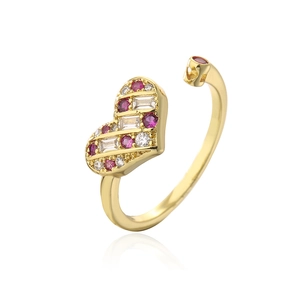 Detail of 18K gold heart ring featuring red and white zircon stones in an open band design