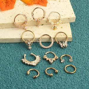Detailed set of 11 golden stainless steel nose rings with zircon charms like bee and butterfly