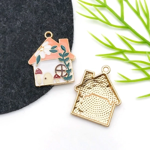 Detailed macro view of enamel house pendant with floral and mushroom motifs