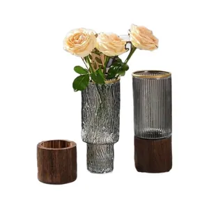 Three-piece set: ribbed glass vases with gold rims and wood container for home decor