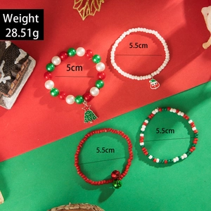 Detailed view of Christmas charm bracelets with Santa and reindeer pendants on festive background