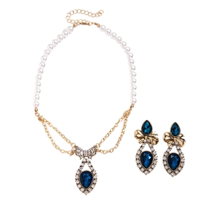 Vintage gold jewelry set with faux pearl necklace and blue teardrop rhinestone bow charms