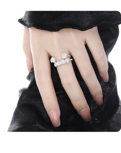 Close-up of S925 sterling silver ring with multiple camellia flowers on a model hand