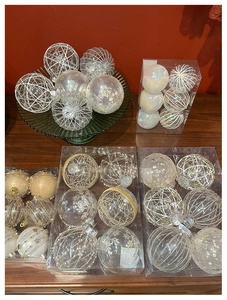 Detail of champagne lace and pearl dot Christmas tree ornaments in clear PVC packaging