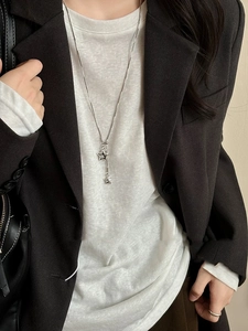 Close-up of minimalist silver double star pendant necklace on a chic snake chain