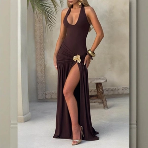 Close-up of the elegant dark brown halter neck dress with a 3D gold flower hardware ornament