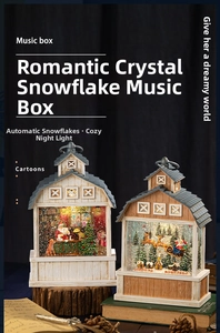 Détail d'une boîte à musique de Noël vintage en forme de grange avec LED et neige