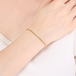 Close-up of minimalist gold thin chain bracelet worn on wrist for an elegant style