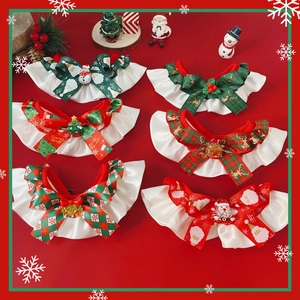 Close-up of festive pet Christmas bow ties and ruffles with reindeer and snowflake patterns