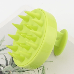 Macro shot of 19 silicone bristles on light green scalp massager for hair washing